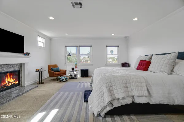 a bedroom with a bed and a fireplace