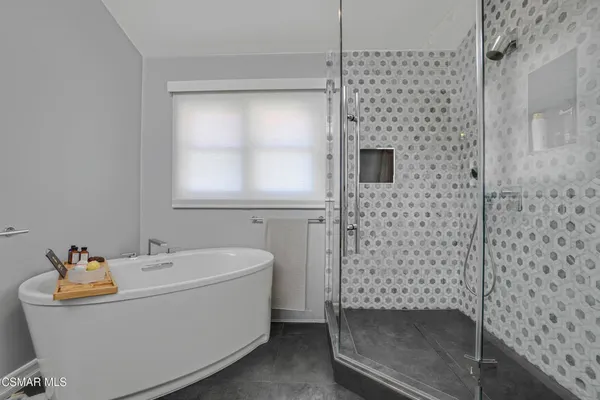 a bathroom with a bathtub and shower