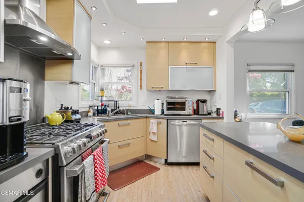 a kitchen with a sink stove top oven and cabinets