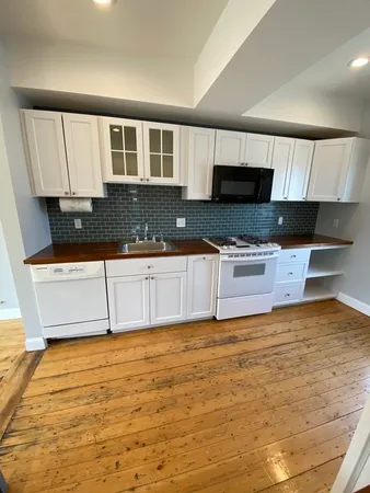 a kitchen with granite countertop a sink and a stove