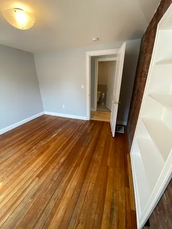 a view of a room with wooden floor and staircase