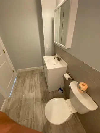 a bathroom with a sink toilet and mirror