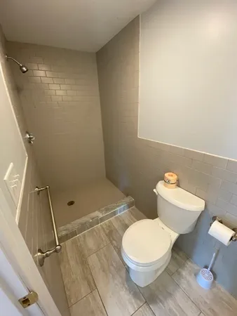 a bathroom with a toilet and a shower
