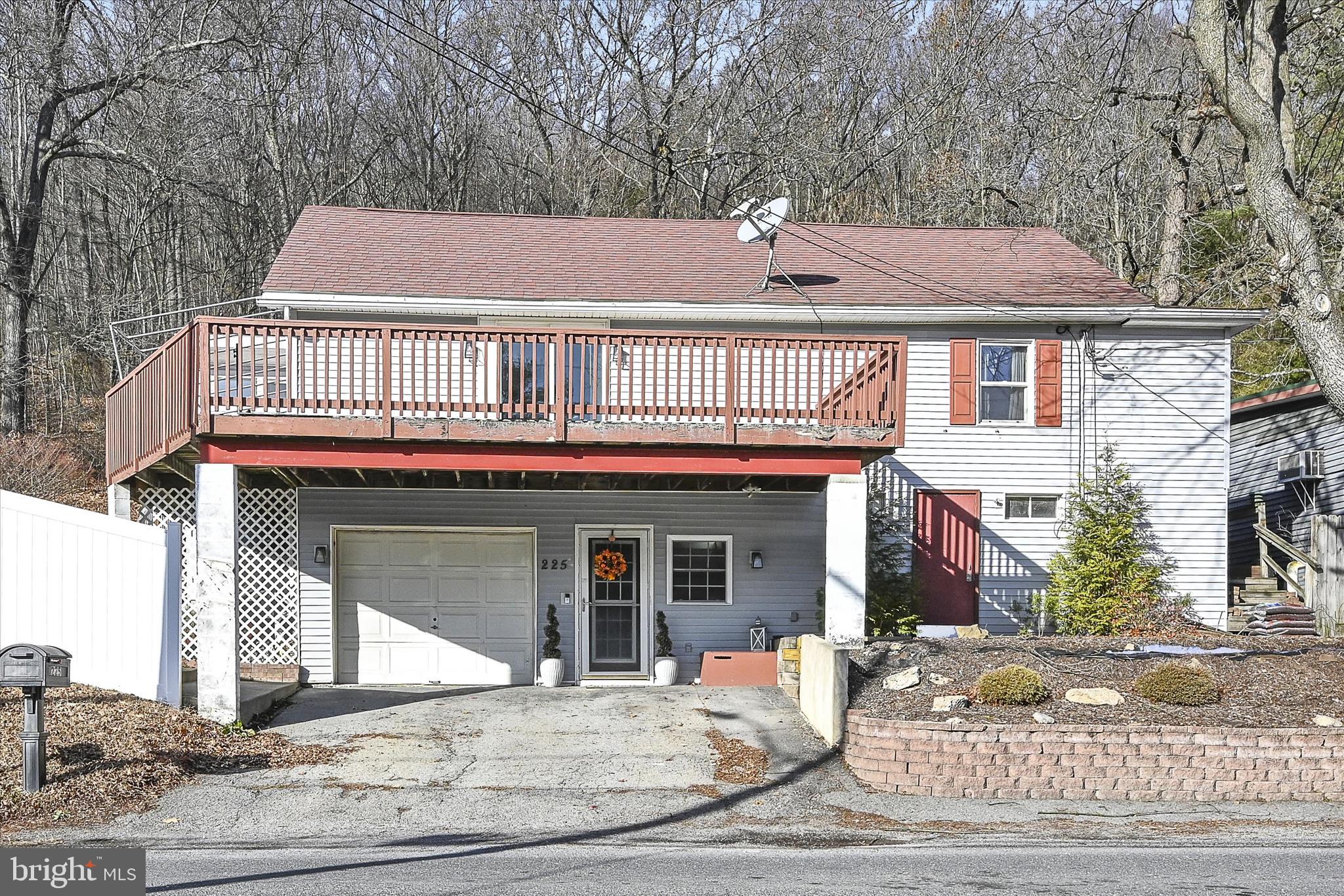 225 Owl Creek Road Tamaqua, PA 18252 - Photo 1 of 46 a front view of a house with garden and seating