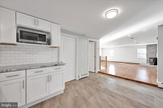 a view of a kitchen with a sink and microwave