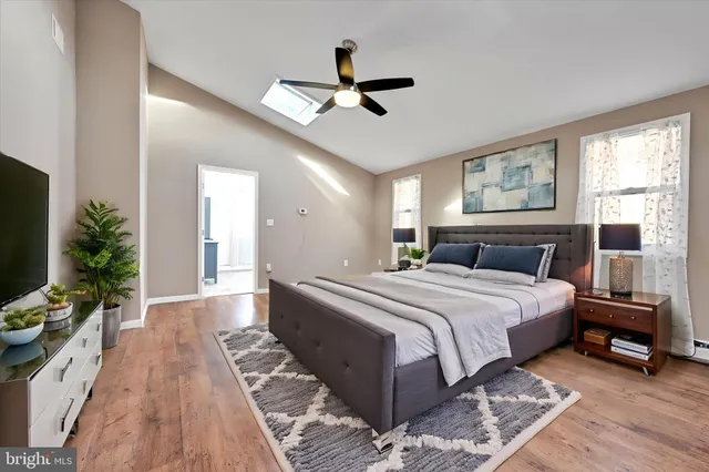 a bedroom with a large bed and a window