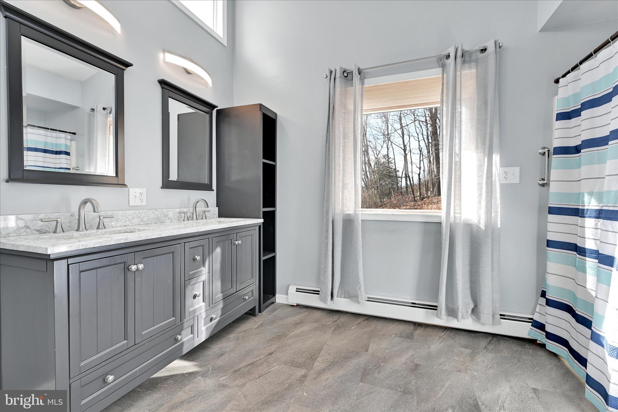 225 Owl Creek Road Tamaqua, PA 18252 - Photo 25 of 46 a spacious bathroom with a double vanity sink and a mirror