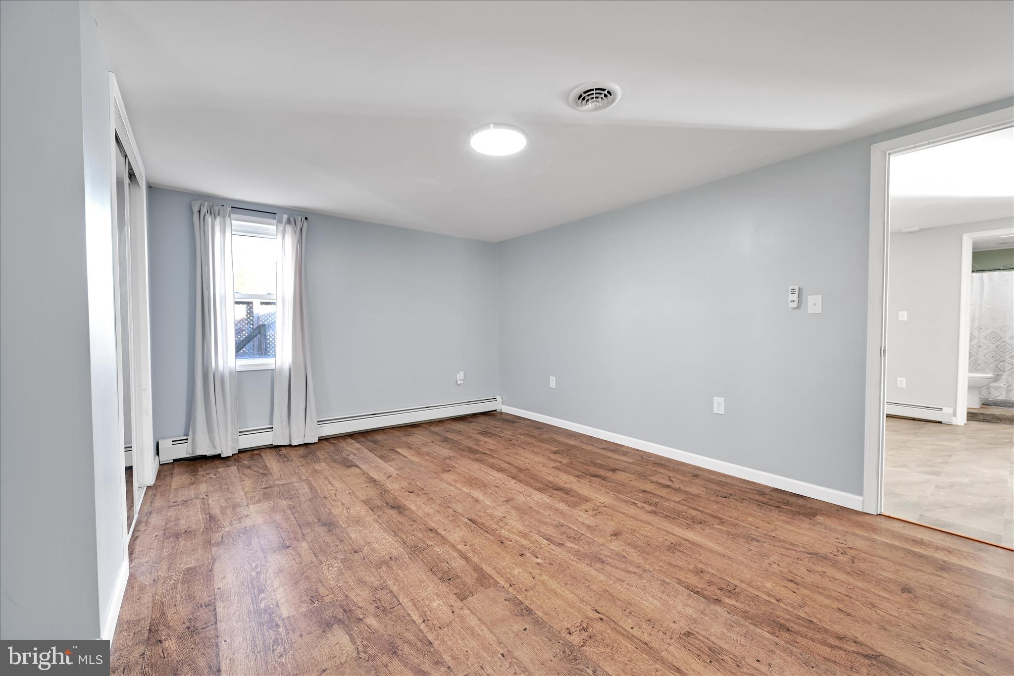 225 Owl Creek Road Tamaqua, PA 18252 - Photo 28 of 46 a view of an empty room with wooden floor and a window