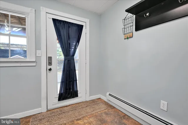 a view of a livingroom with wooden floor and a large window