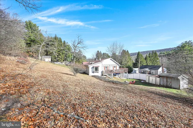 a view of a house with a yard and sitting area