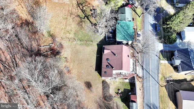 an aerial view of residential house with outdoor space and trees