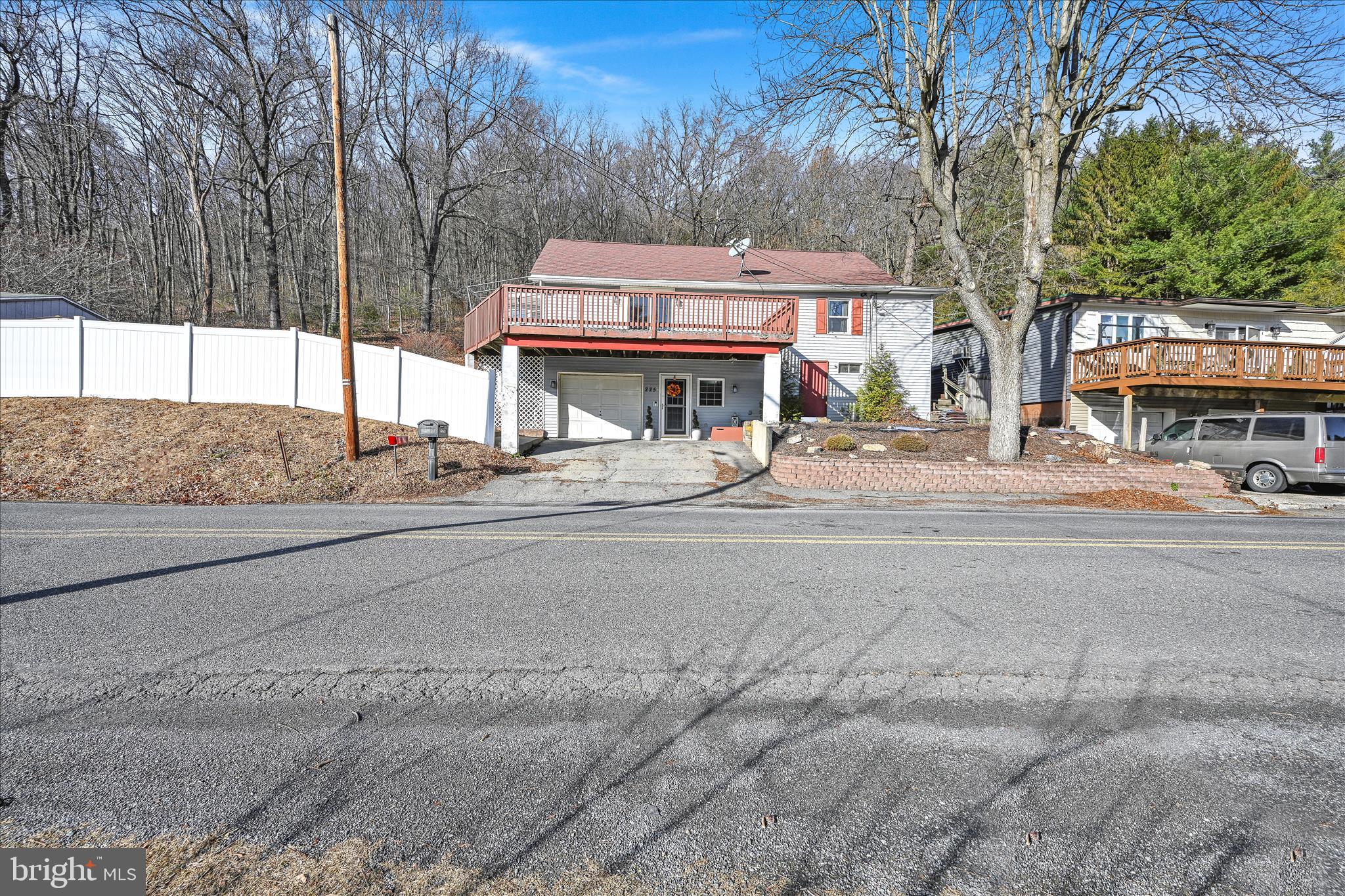 225 Owl Creek Road Tamaqua, PA 18252 - Photo 6 of 46 a house view with a sitting space and large trees