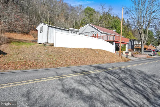 a view of a house with a snow on the road