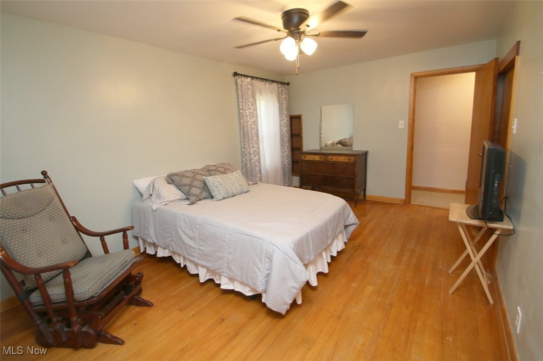 2802 South Ridge Road East Kingsville, OH 44048 - Photo 19 of 42 Bedroom featuring wood finished floors and a ceiling fan