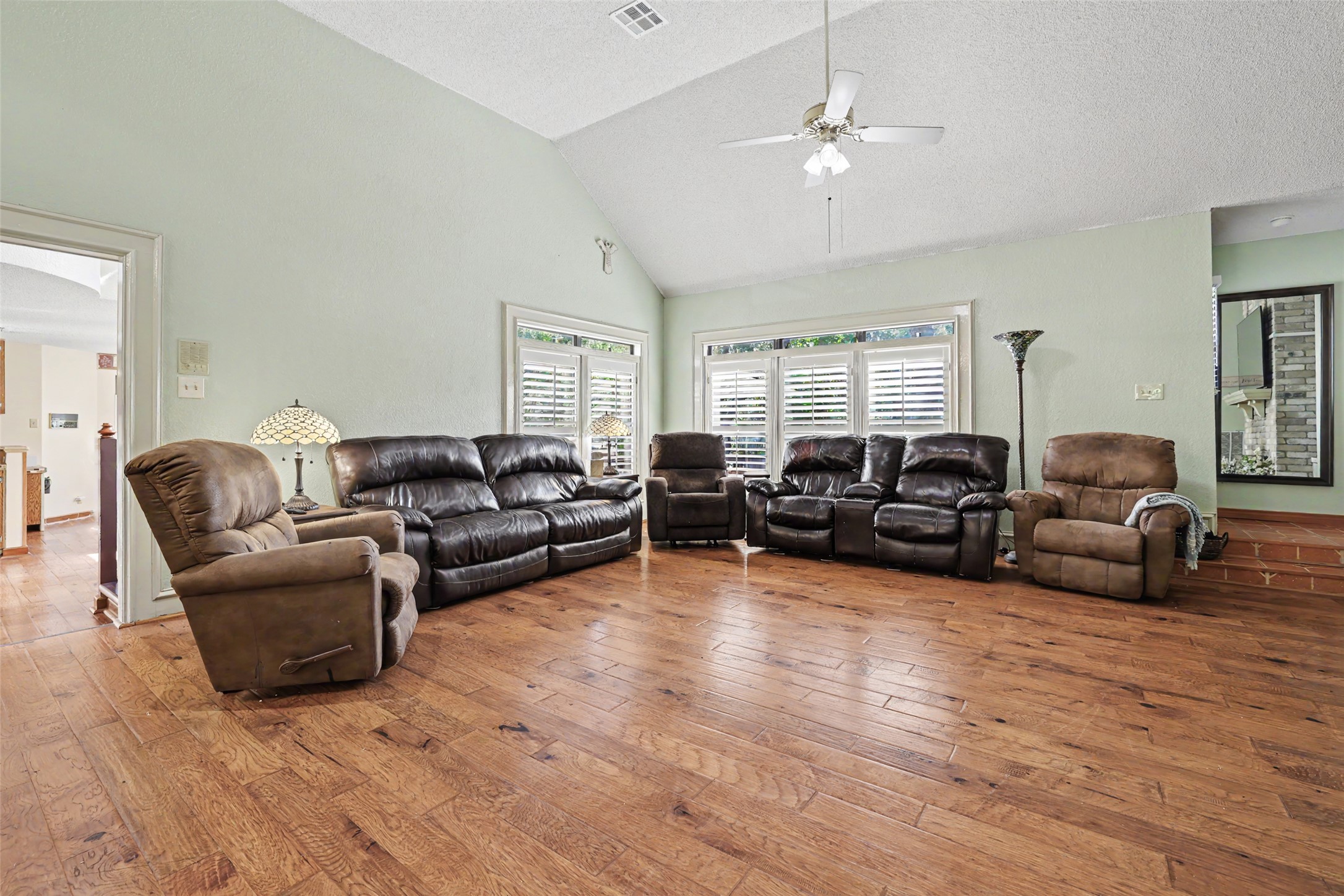 110 South Ridge Circle Georgetown, TX 78628 - Photo 9 of 37 Spacious living area featuring wood-finish flooring, vaulted ceilings, and a ceiling fan with integrated lighting