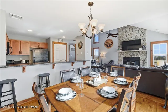 a view of a dining room with furniture and a chandelier
