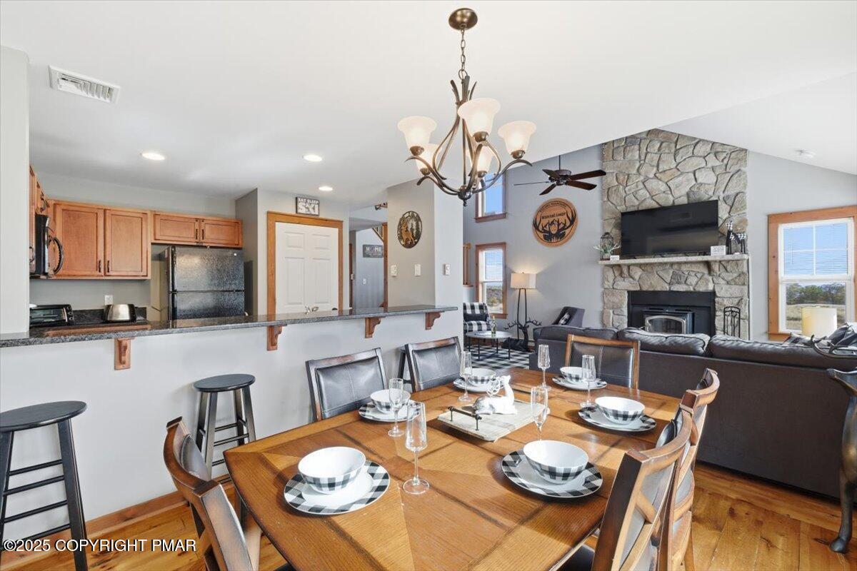 557 Upper Deer Valley Road Tannersville, PA 18372 - Photo 11 of 47 a view of a dining room with furniture and a chandelier