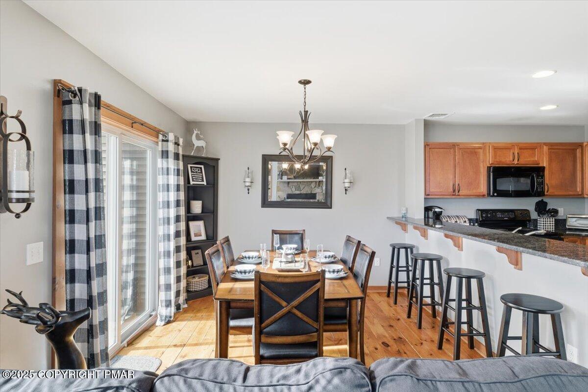 557 Upper Deer Valley Road Tannersville, PA 18372 - Photo 12 of 47 a dining room with furniture window and wooden floor