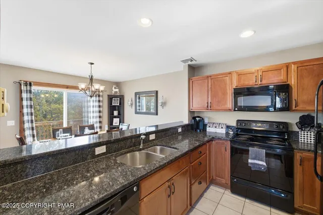 a kitchen with stainless steel appliances granite countertop a sink stove and microwave