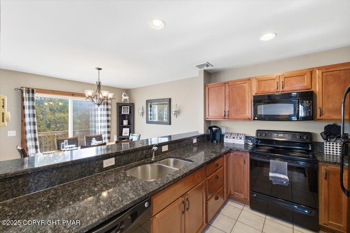 557 Upper Deer Valley Road Tannersville, PA 18372 - Photo 15 of 47 a kitchen with stainless steel appliances granite countertop a sink stove and microwave