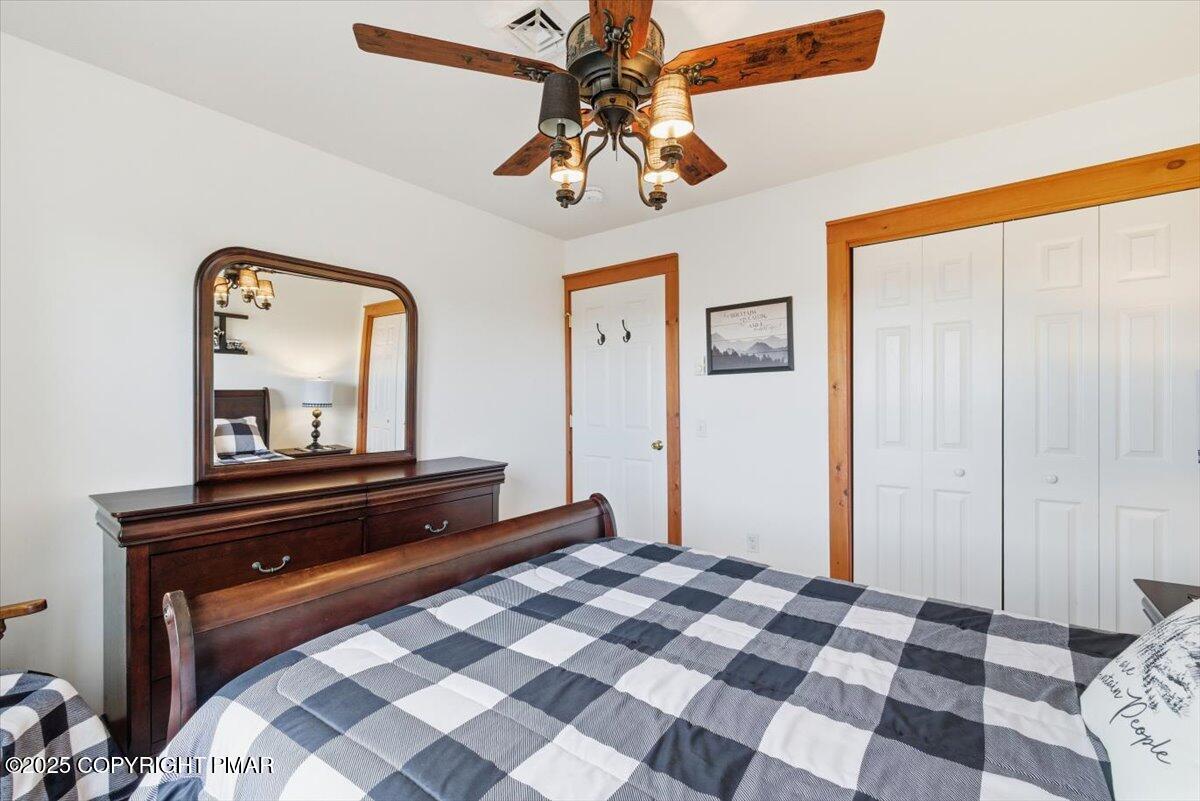 557 Upper Deer Valley Road Tannersville, PA 18372 - Photo 20 of 47 a bedroom with a bed and a mirror on dresser