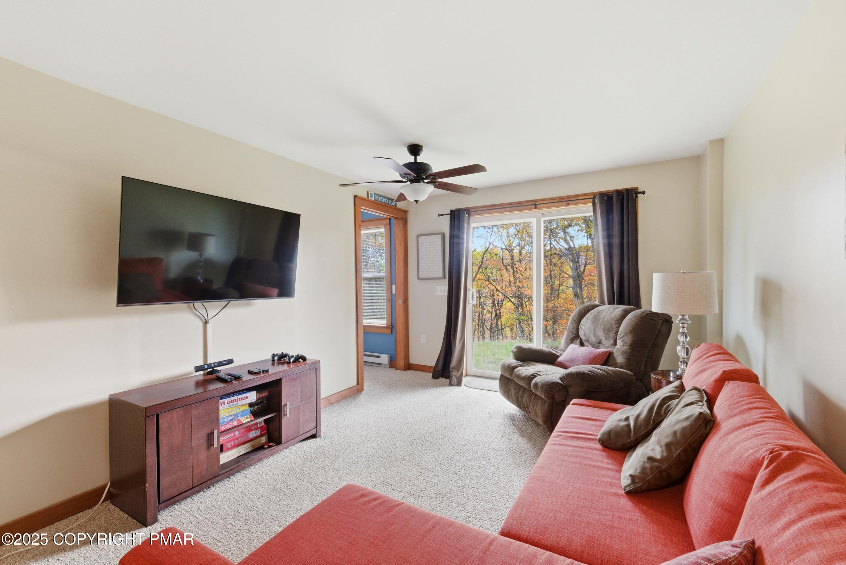 557 Upper Deer Valley Road Tannersville, PA 18372 - Photo 31 of 47 a living room with furniture and a flat screen tv