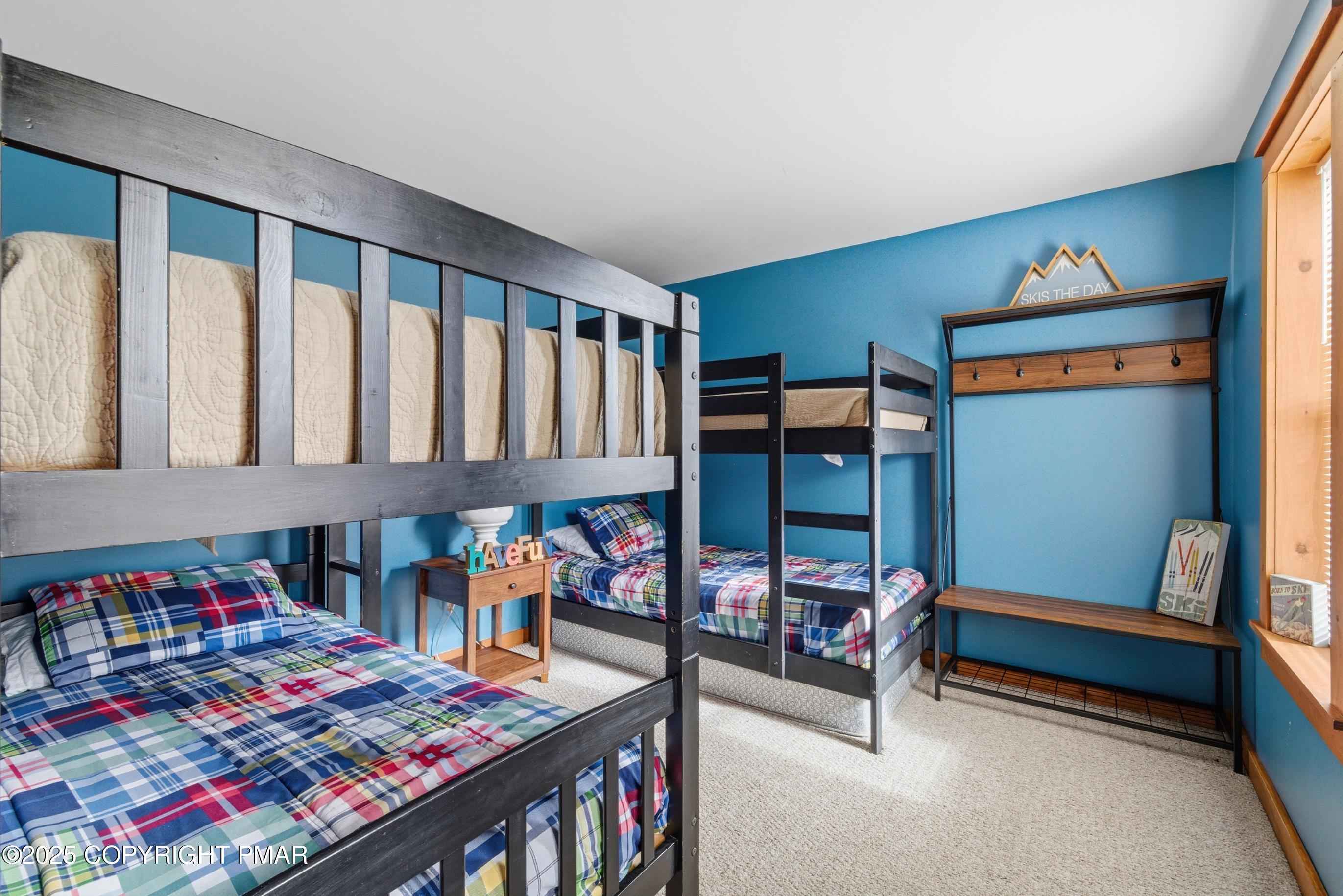 557 Upper Deer Valley Road Tannersville, PA 18372 - Photo 33 of 47 a bedroom with furniture and a book shelf