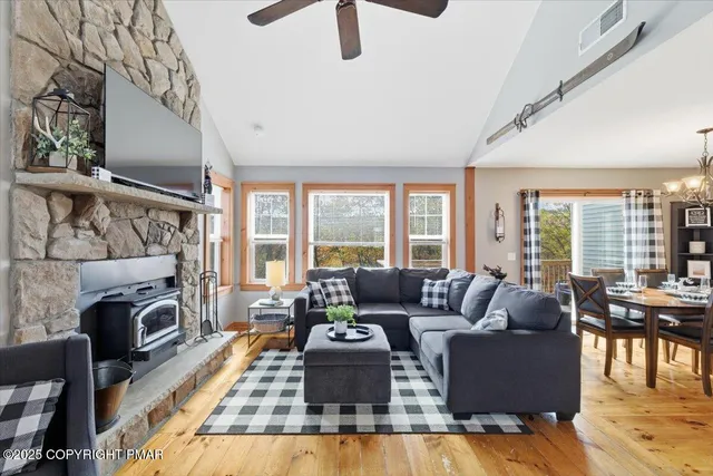 a living room with furniture fireplace and a large window