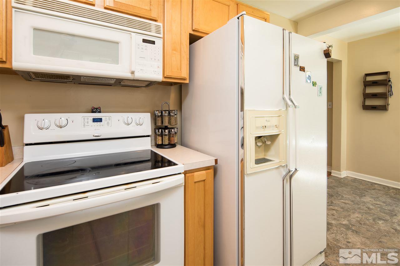 70 Bisby Street Reno, NV 89512 - Photo 8 of 25 a kitchen with a refrigerator and a stove