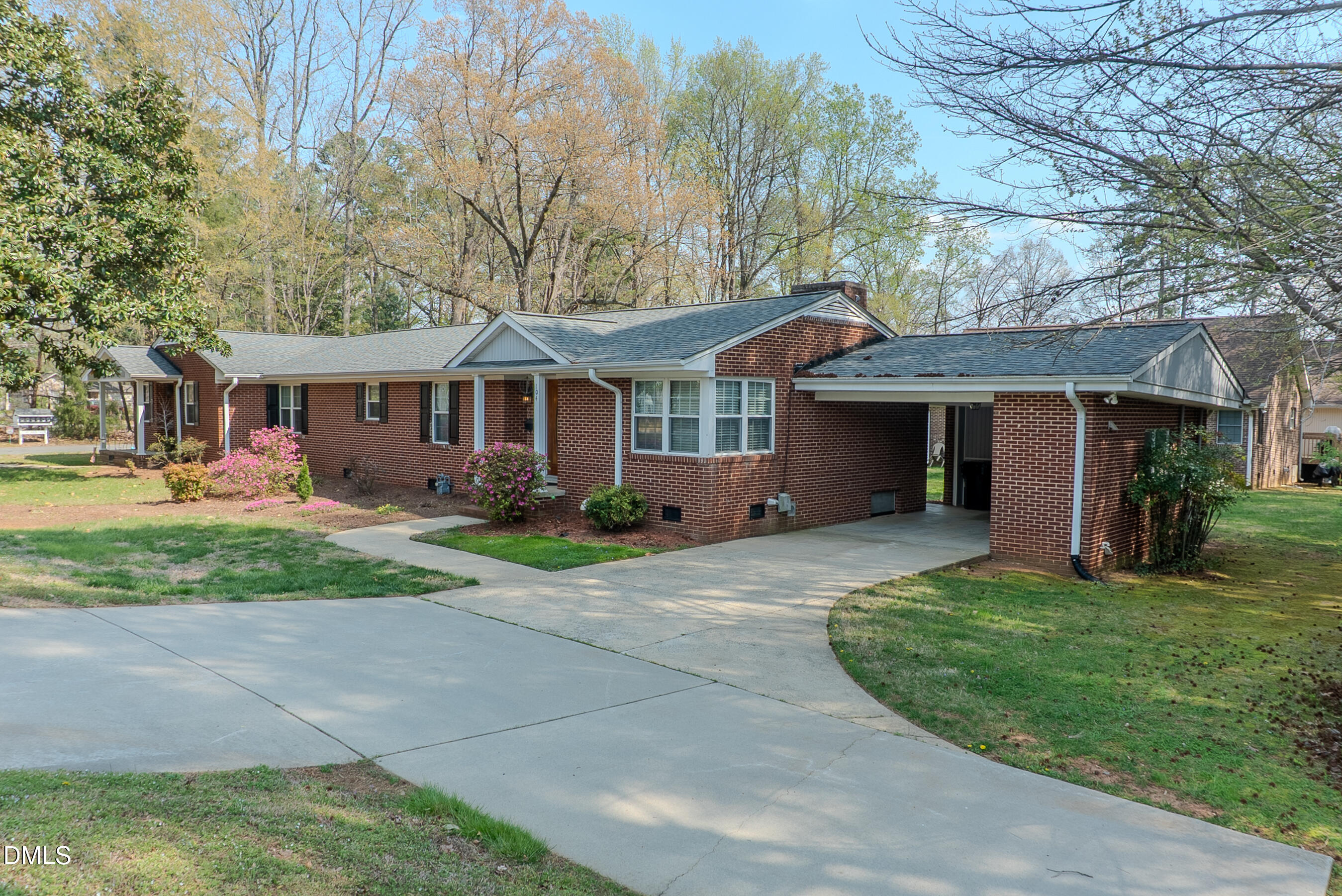 2012 South Mebane Street, Unit 102 Burlington, NC 27215 - Photo 17 of 35 a front view of a house with a yard and trees