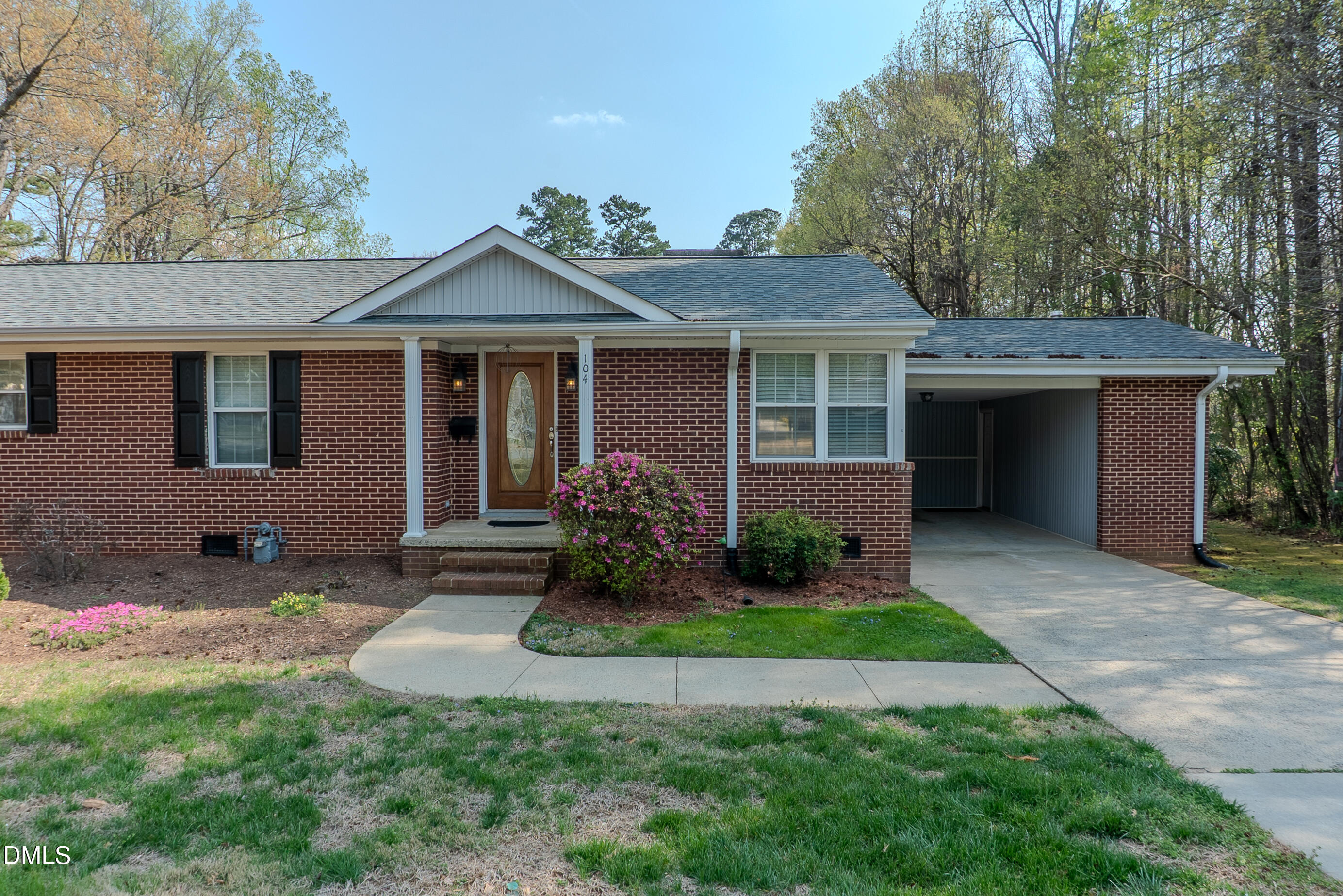 2012 South Mebane Street, Unit 102 Burlington, NC 27215 - Photo 18 of 35 a front view of a house with a garden and yard