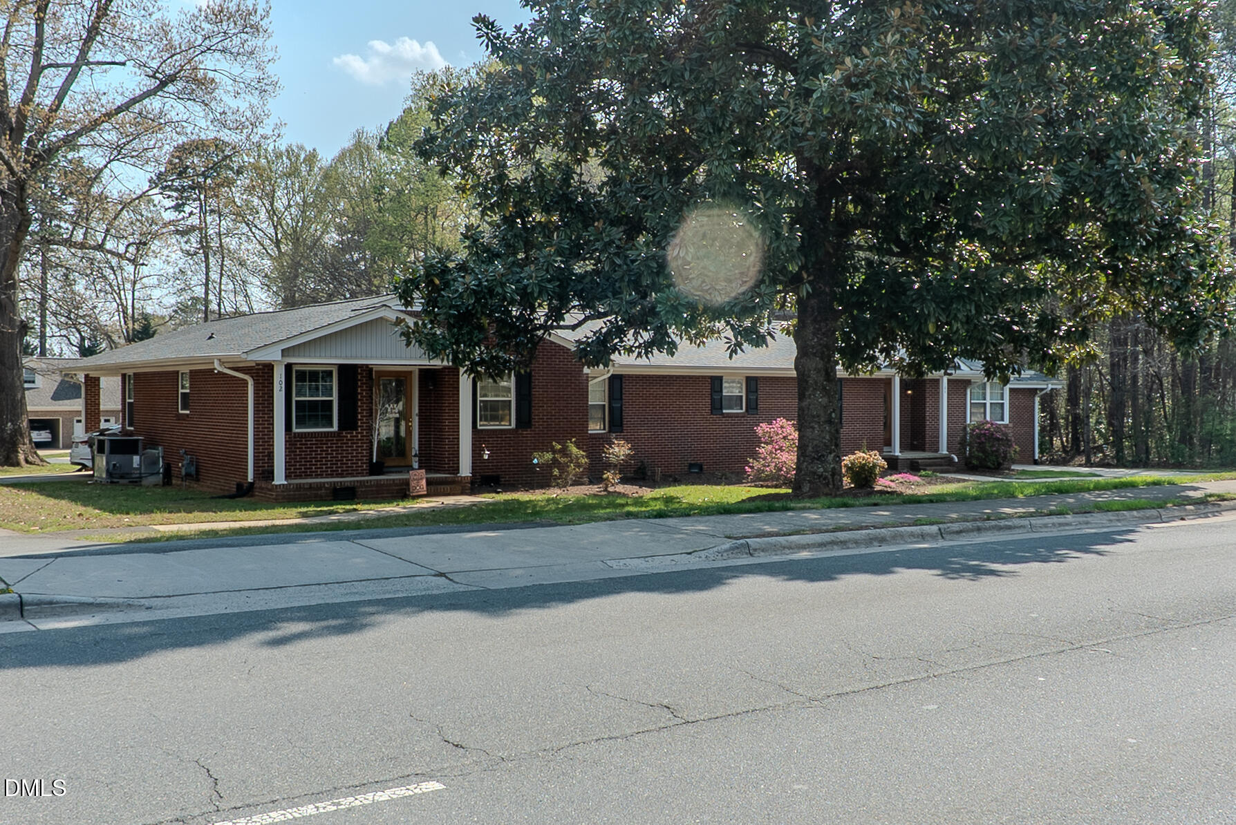 2012 South Mebane Street, Unit 102 Burlington, NC 27215 - Photo 21 of 35 a view of a house with a yard and large tree