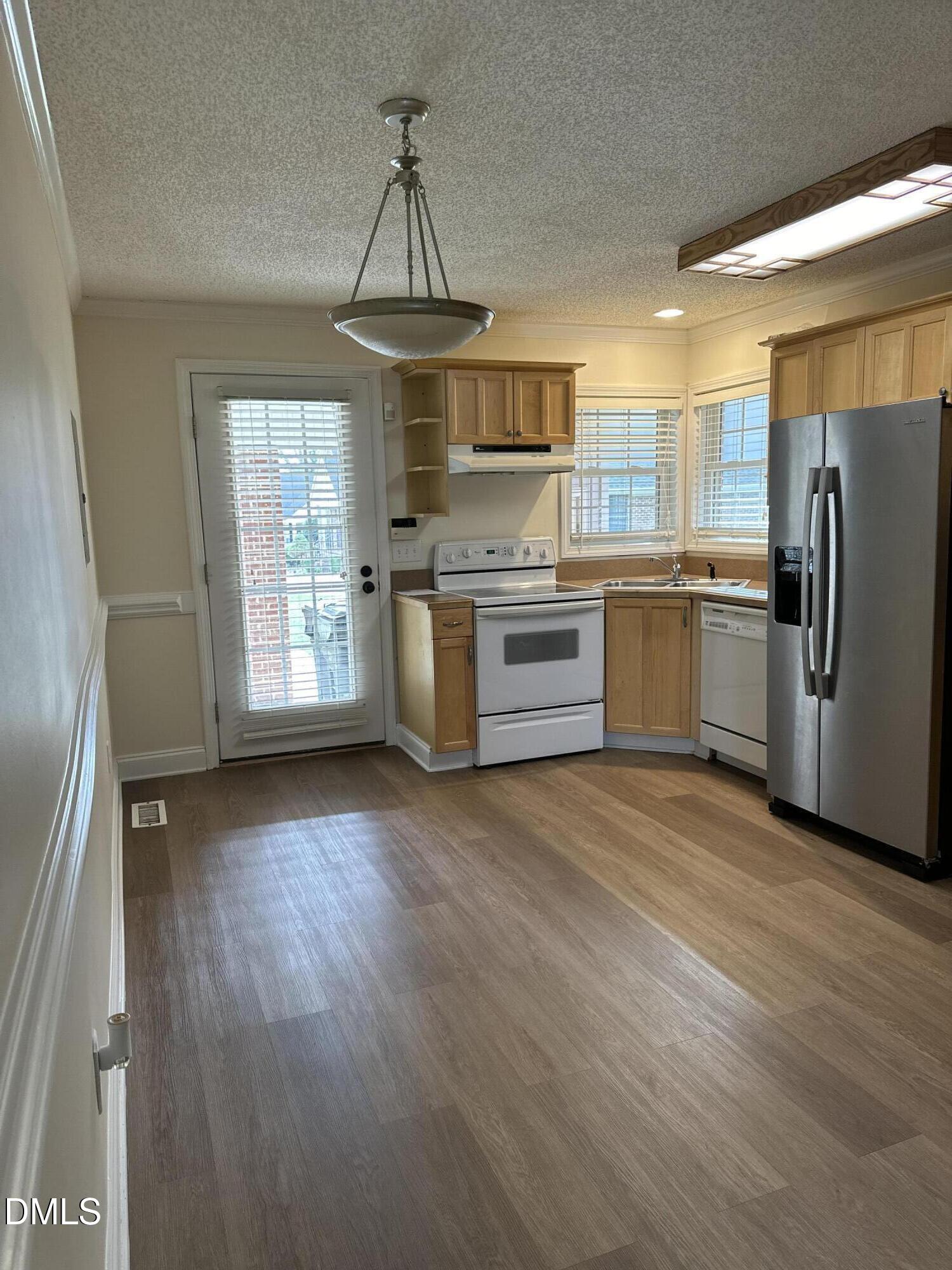 2012 South Mebane Street, Unit 102 Burlington, NC 27215 - Photo 26 of 35 a kitchen with stainless steel appliances granite countertop a stove a refrigerator and a sink