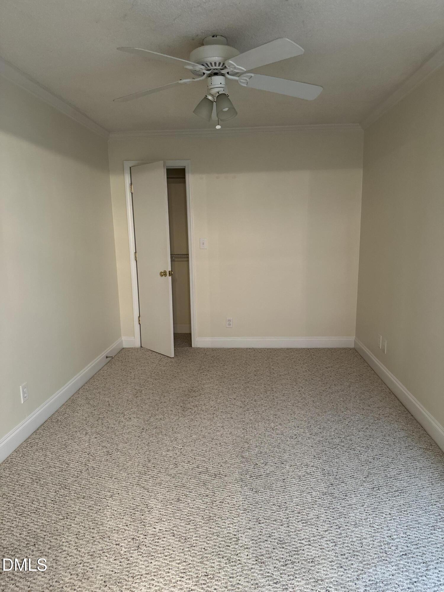 2012 South Mebane Street, Unit 102 Burlington, NC 27215 - Photo 34 of 35 an empty room with a ceiling fan and a window