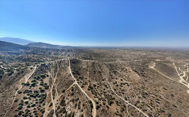 an aerial view of residential houses with city view