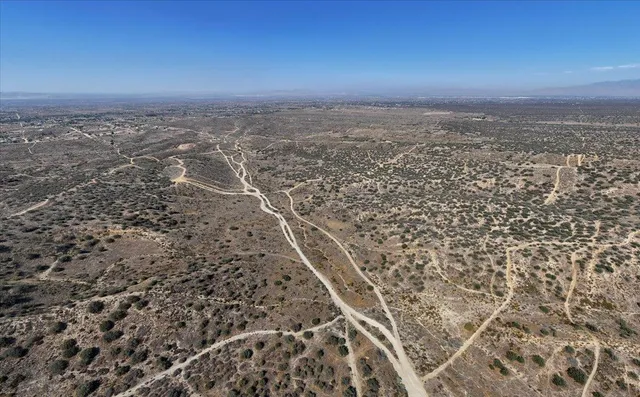 an aerial view of a residential houses with city view