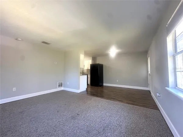 an empty room with large windows