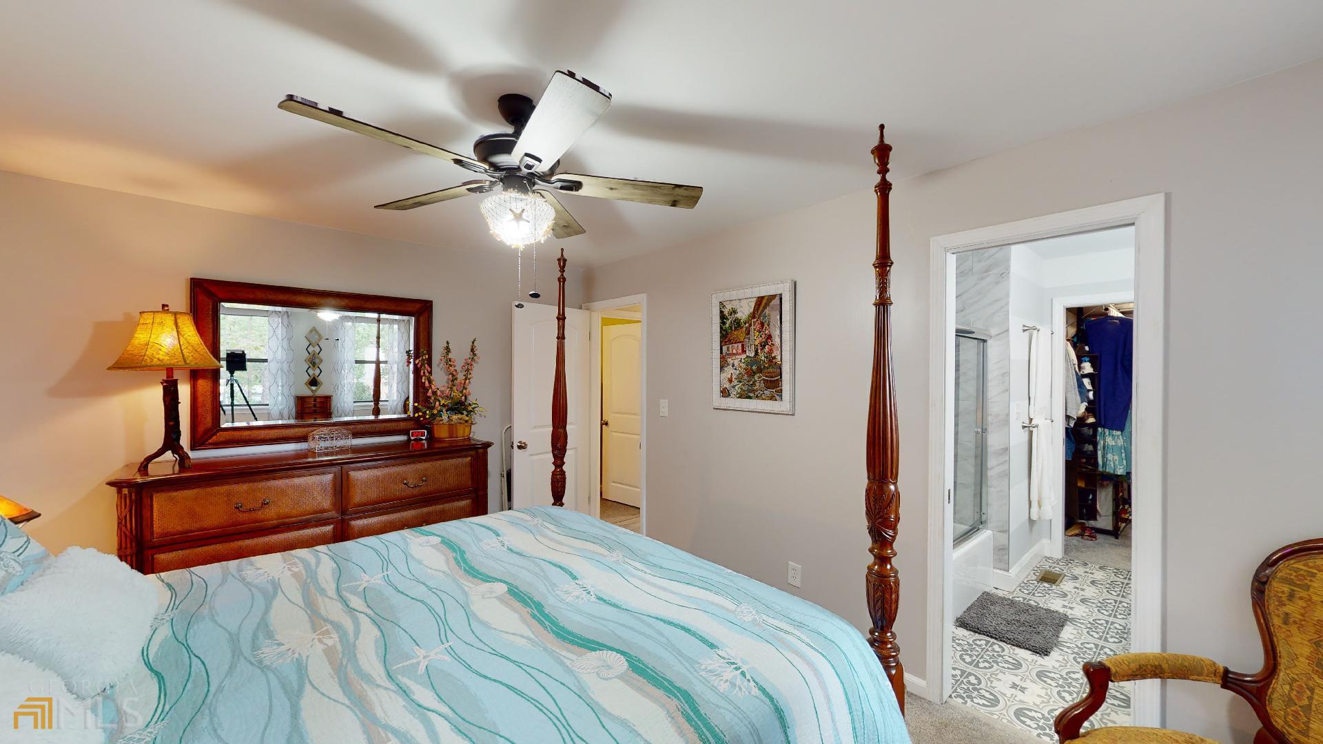 1137 Magnolia Drive Villa Rica, GA 30180 - Photo 15 of 44 a bedroom with chandelier and wooden floor