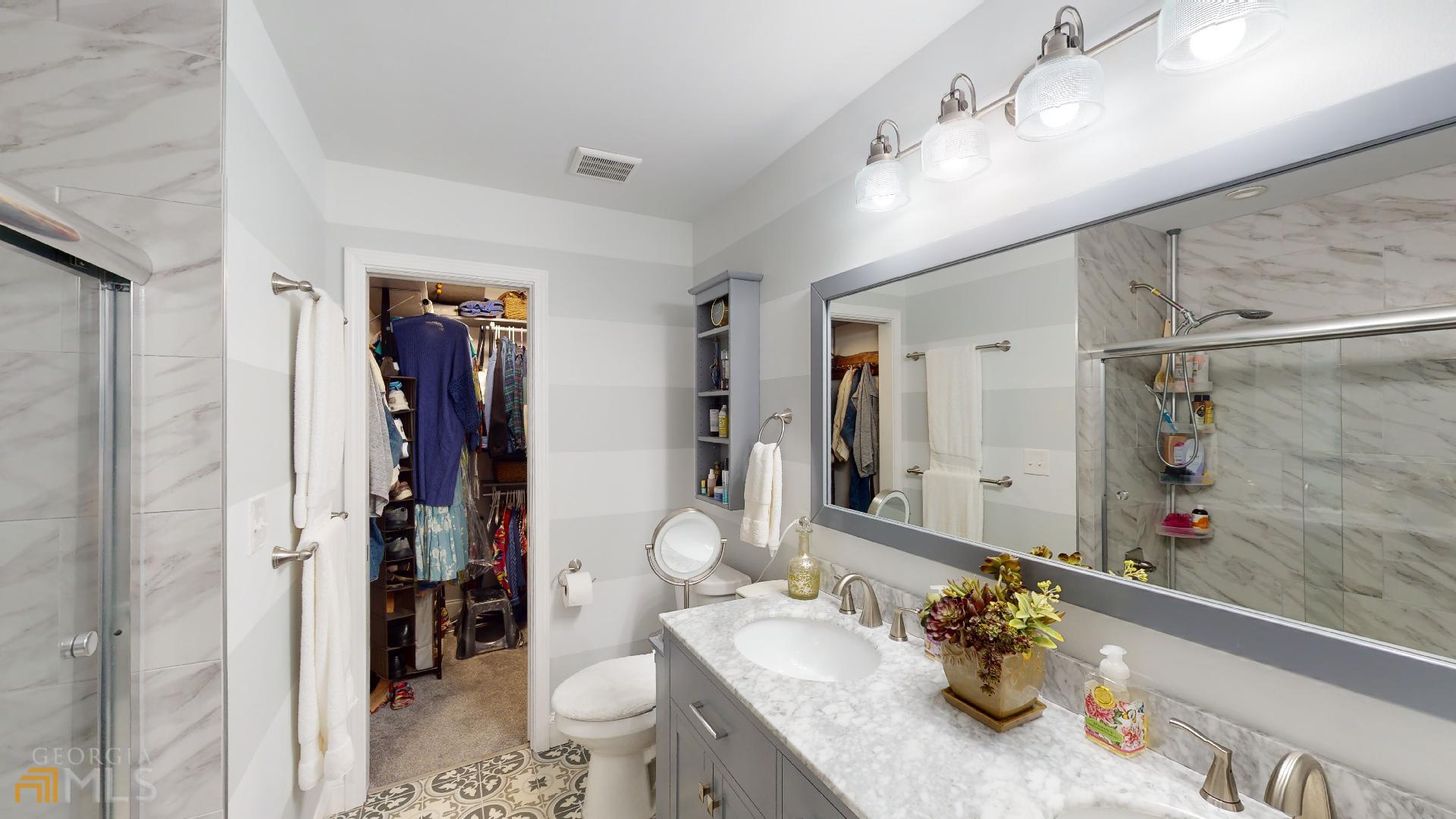 1137 Magnolia Drive Villa Rica, GA 30180 - Photo 16 of 44 a bathroom with a granite countertop sink a toilet and shower
