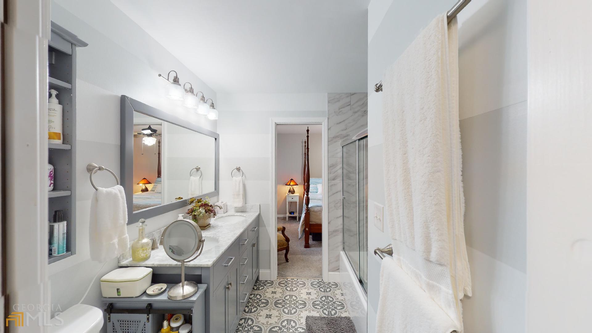 1137 Magnolia Drive Villa Rica, GA 30180 - Photo 17 of 44 a bathroom with a toilet mirror and a sink