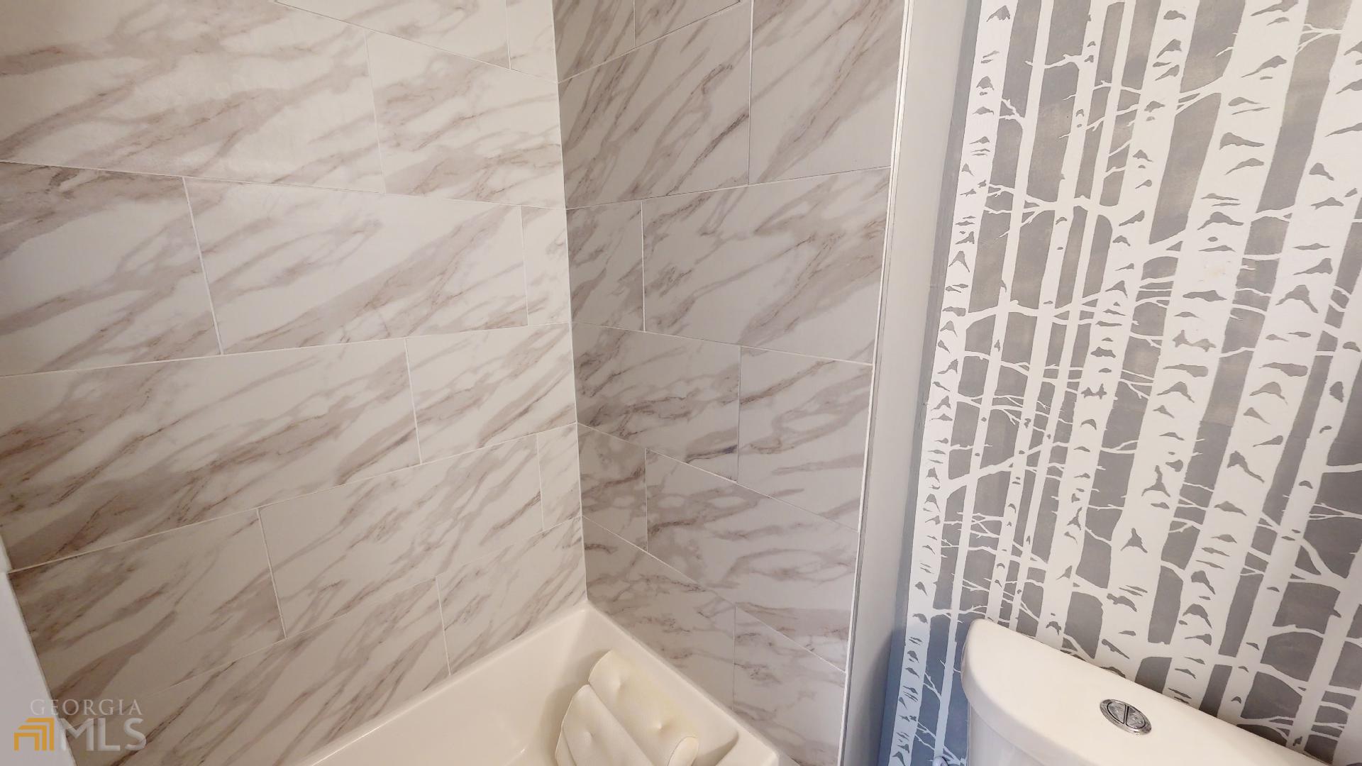 1137 Magnolia Drive Villa Rica, GA 30180 - Photo 23 of 44 a bathroom with a toilet and a shower curtain