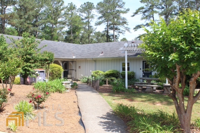 1137 Magnolia Drive Villa Rica, GA 30180 - Photo 40 of 44 a view of a patio with table and chairs potted plants and large tree