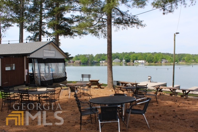 1137 Magnolia Drive Villa Rica, GA 30180 - Photo 44 of 44 a view of a patio with furniture and lake view
