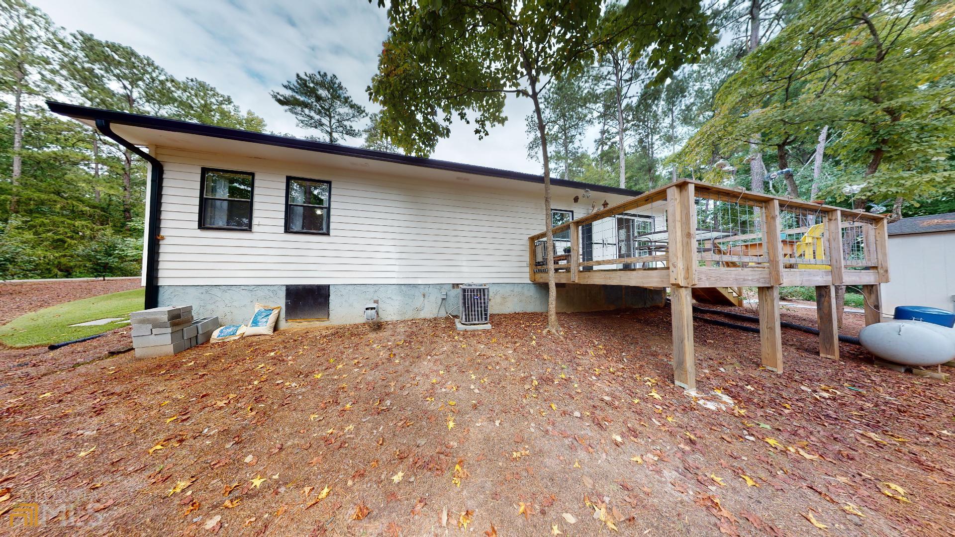 1137 Magnolia Drive Villa Rica, GA 30180 - Photo 5 of 44 a view of a house with a backyard and a patio