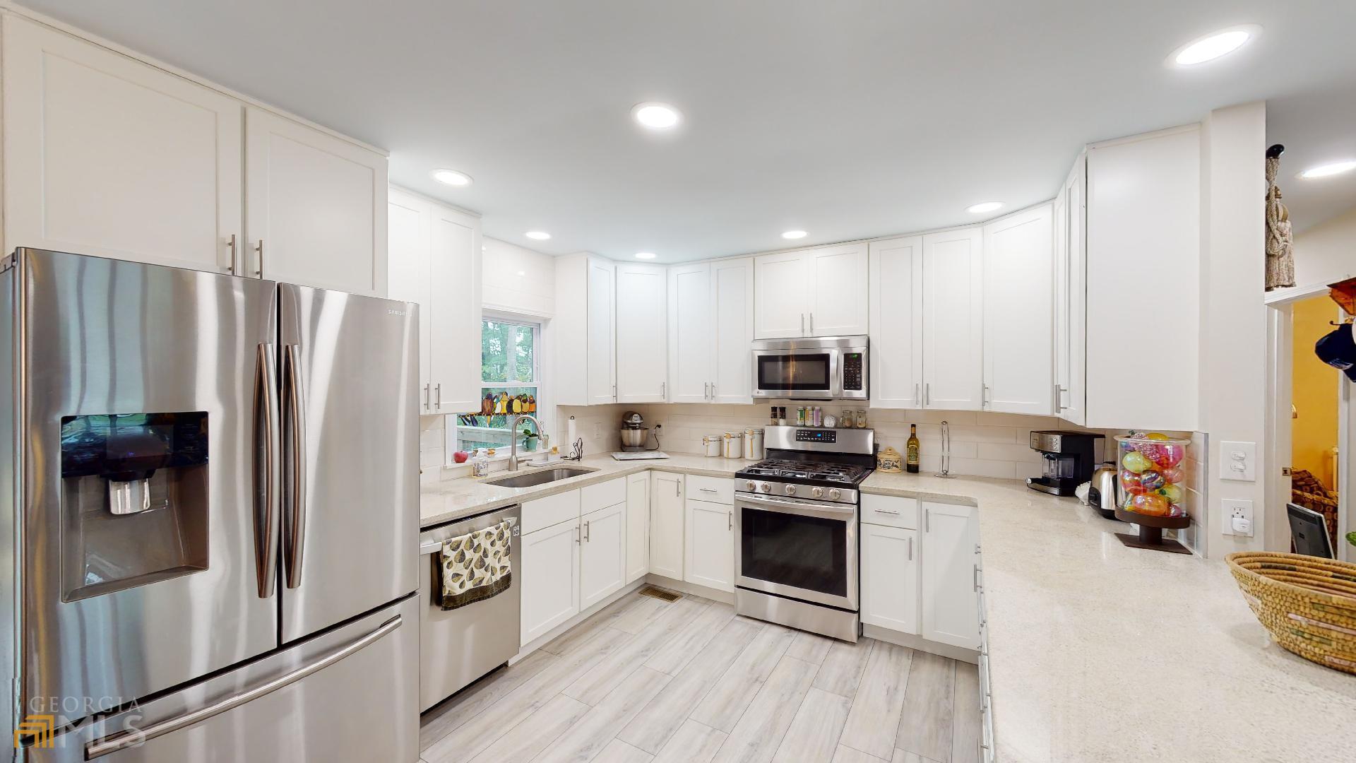 1137 Magnolia Drive Villa Rica, GA 30180 - Photo 10 of 44 a kitchen with stainless steel appliances a refrigerator sink and microwave
