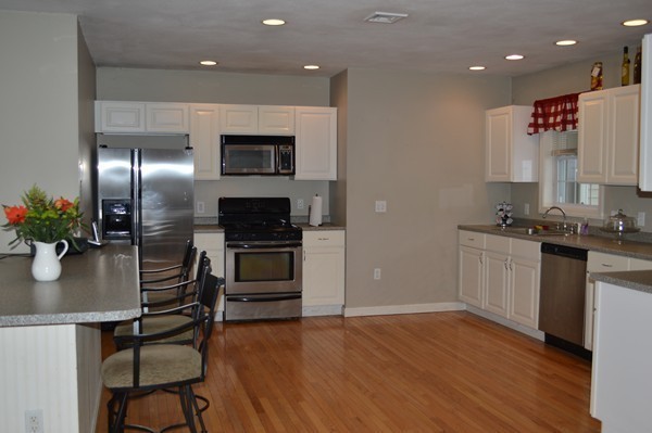 3 Sand Hill Road Salisbury, MA 01952 - Photo 3 of 15 a kitchen with granite countertop stainless steel appliances and wooden floor