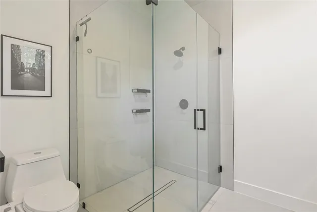 a bedroom with a bed and a lamp on the dresser