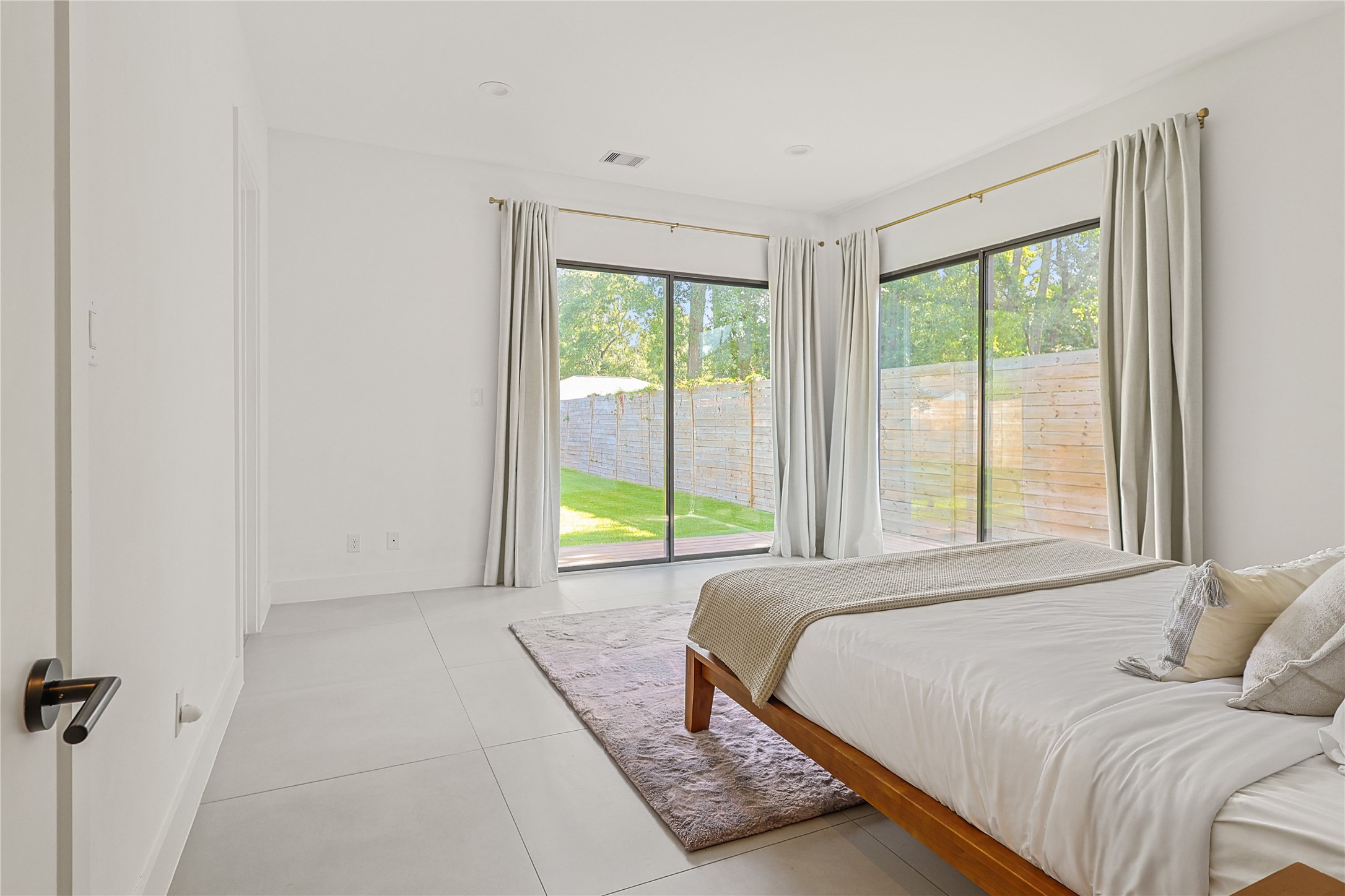 1550 Ashway Street Conroe, TX 77385 - Photo 25 of 34 a bed sitting in a bedroom next to a window