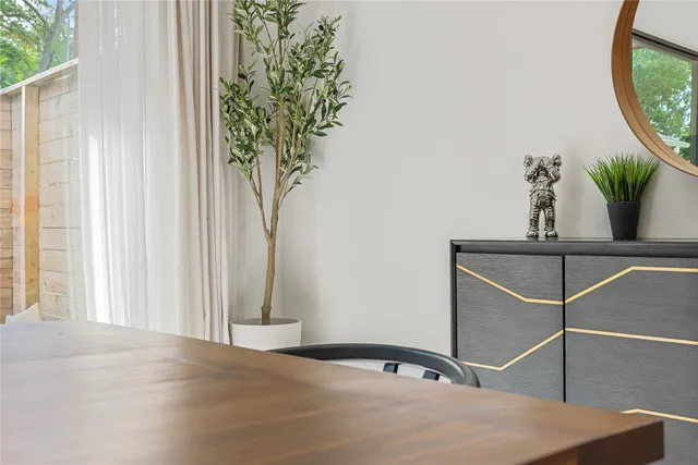 a room with pool table and windows