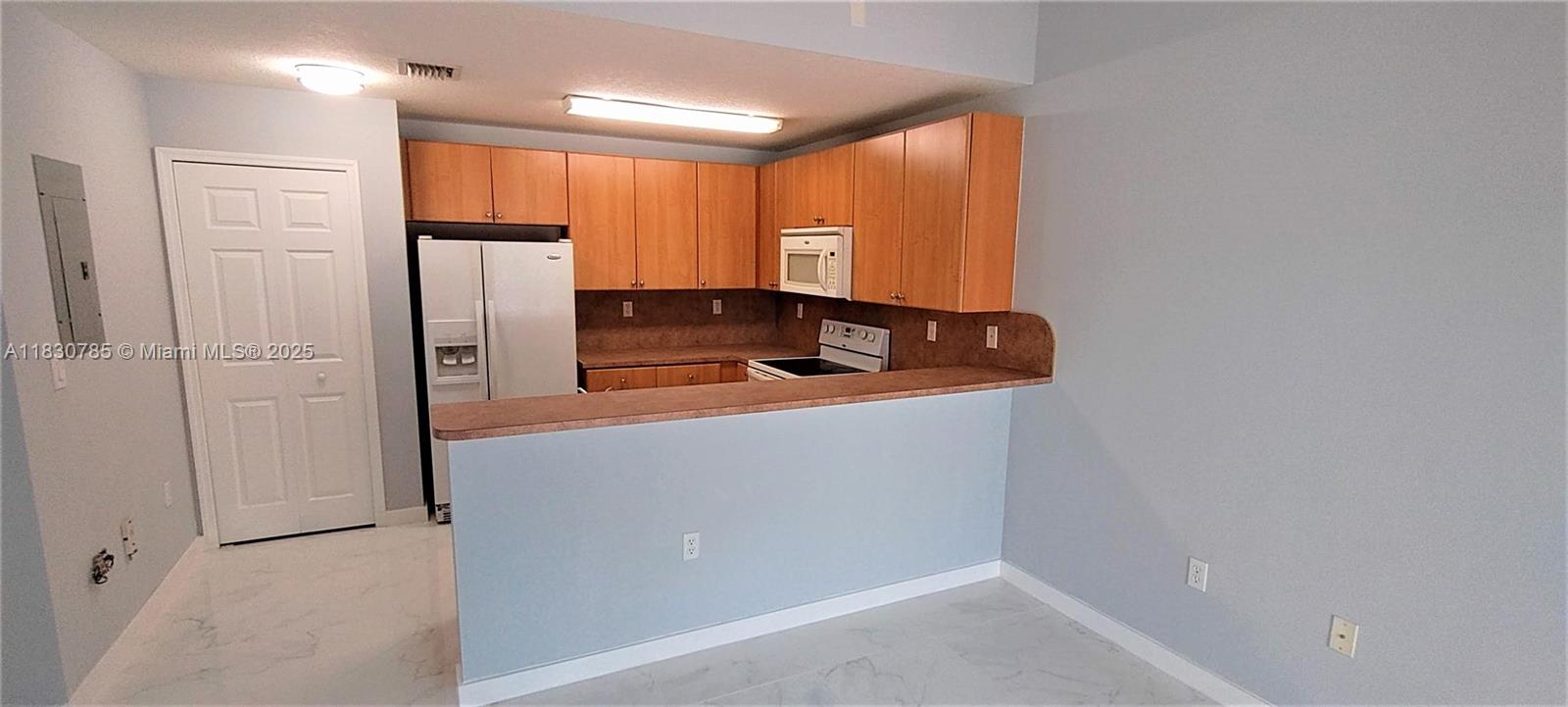 22911 Southwest 88th Place, Unit 721 Cutler Bay, FL 33190 - Photo 13 of 20 a kitchen with stainless steel appliances granite countertop a refrigerator and a sink